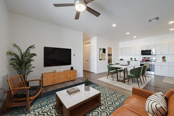 Phoenix apartment for rent - A living room with a brown chair and a white coffee table.