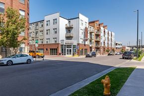 Denver apartment for rent - a city street with buildings and a yellow fire hydrant