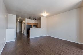 Denver apartment for rent - an empty living room and kitchen with a wood floor