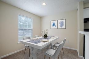 Frederick apartment for rent - A dining room with a white table and chairs.