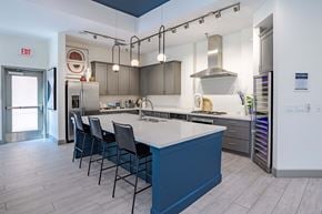 Colorado Springs apartment for rent - a kitchen with a blue island and white counter tops and gray cabinets