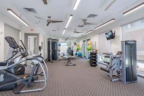 Colorado Springs apartment for rent - a gym with cardio equipment and weights at the renaissance atlantic yards apartments