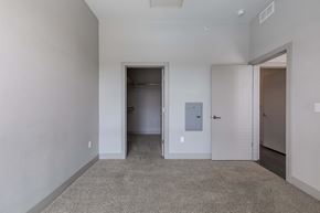 Denver apartment for rent - a bedroom with a closet and a door to a hallway