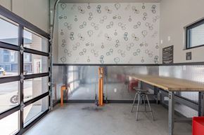 Denver apartment for rent - a dining room with a table and chairs and a wall with bikes on it