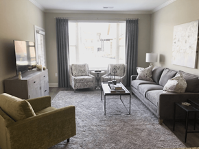 Gallatin apartment for rent - A living room with a brown sofa, a white armchair, and a grey chair.