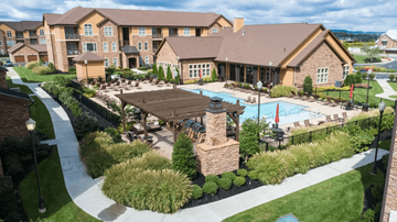 Gallatin apartment for rent - A large building with a pool in front of it.