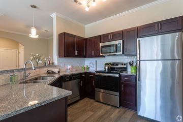 Gallatin apartment for rent - A kitchen with dark wood cabinets and stainless steel appliances.