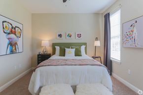 Gallatin apartment for rent - A bedroom with a white bed and two white fluffy bedsheets.
