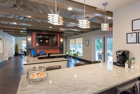 Hanover apartment for rent - Clubhouse kitchen with a marble countertop and a flat-screen TV above the island.