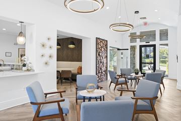 Overland Park apartment for rent - A living room with blue chairs and a wooden floor.