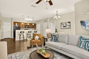 Hendersonville apartment for rent - A living room with a couch, chair, and a table with a pineapple on it.