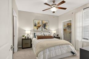 Hendersonville apartment for rent - A bedroom with a large bed and a ceiling fan.