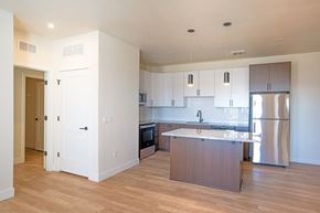 Commerce City apartment for rent - A kitchen with a wooden island and stainless steel appliances.