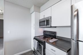 Northglenn apartment for rent - a kitchen with stainless steel appliances and white cabinets