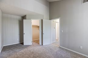 Northglenn apartment for rent - an empty bedroom with open doors to a closet