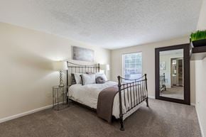 Frederick apartment for rent - a bedroom with a bed and a mirror