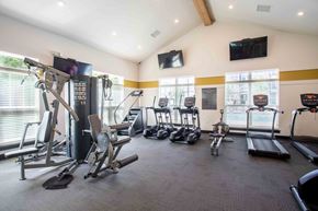 Clarksville apartment for rent - a gym with weights and cardio equipment in a room with windows