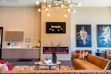 Reno apartment for rent - A living room with a fireplace and a painting on the wall.