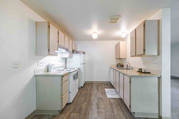 Vancouver apartment for rent - A kitchen with white appliances and wooden floors.