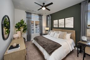 Kennesaw apartment for rent - Bedroom with bed, accent wall, dresser, ceiling fan, and nightstands