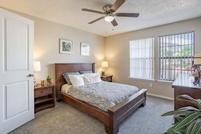 Colorado Springs apartment for rent - a bedroom with a bed and a ceiling fan