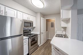 Colorado Springs apartment for rent - a kitchen with stainless steel appliances and white cabinets