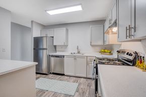 Tigard apartment for rent - a white kitchen with stainless steel appliances and white counter tops