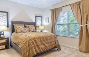 Dumfries apartment for rent - A bedroom with a bed, nightstand, and window.