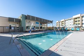 Maricopa apartment for rent - A swimming pool and a building in the background.