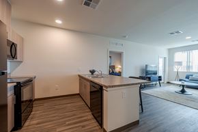 Maricopa apartment for rent - A kitchen with a refrigerator, dishwasher, and a countertop with a sink.