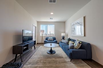 Maricopa apartment for rent - A living room with a blue couch and a television.