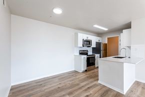 Fort Collins apartment for rent - A kitchen with white cabinets and a wooden floor.