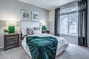 Fort Collins apartment for rent - a bedroom with a large bed and a large window