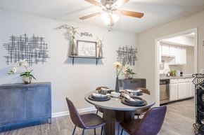 Nashville apartment for rent - our dining room and kitchen with a table and chairs and a ceiling fan