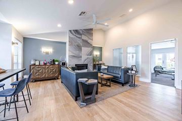 Austin apartment for rent - A modern living room with a grey sofa and a wooden floor.
