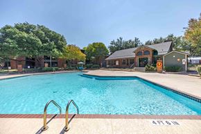 Austin apartment for rent - A large swimming pool with a building in the background.