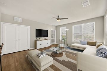 Georgetown apartment for rent - A living room with a brown rug and a white sofa.