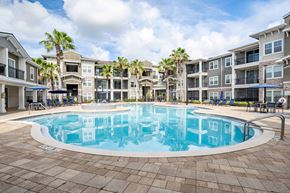 Orlando apartment for rent - A large swimming pool in front of apartment buildings.