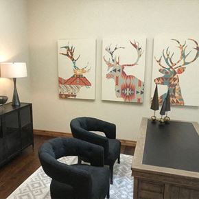 Steamboat Springs apartment for rent - a living room with two chairs and paintings of deer