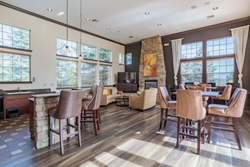 Colorado Springs apartment for rent - a living room with a table and chairs and a fireplace