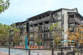Nashville apartment for rent - a building with a pool and a fence in front of it