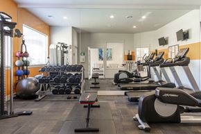 Vancouver apartment for rent - a gym filled with cardio equipment and weights