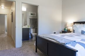 Vancouver apartment for rent - a bedroom with a bed and a bathroom with a toilet