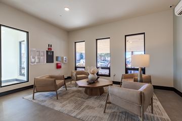 Aurora apartment for rent - A living room with a grey carpet and beige chairs.