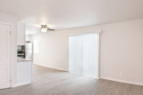 Sparks apartment for rent - A spacious living room with a ceiling fan and a cabinet.