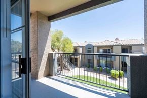 Phoenix apartment for rent - A view from a doorway looking out to a courtyard with a building in the background.