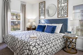 Murfreesboro apartment for rent - a bedroom with a bed and two windows