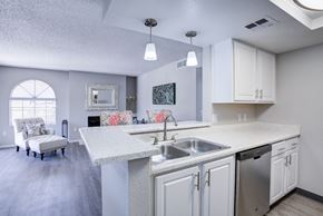 Tuscon apartment for rent - A kitchen with a white counter top and a stainless steel dishwasher.