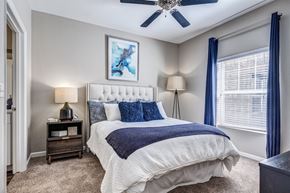 Broomfield apartment for rent - a bedroom with a bed and a ceiling fan