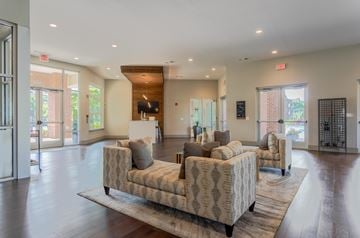 Murfreesboro apartment for rent - A spacious living room with a patterned sofa and a wooden coffee table.